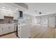 Modern kitchen with white cabinets, stainless steel appliances, and breakfast bar at 4321 Tahitian Gardens Cir # A, Holiday, FL 34691