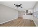 Open concept living room with wood-look floors and access to kitchen at 4321 Tahitian Gardens Cir # A, Holiday, FL 34691