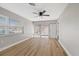 Bright living room with wood-look floors and access to patio at 4321 Tahitian Gardens Cir # A, Holiday, FL 34691