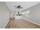 Light and airy living room with wood-look floors and ceiling fan at 4321 Tahitian Gardens Cir # A, Holiday, FL 34691