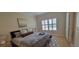 Cozy bedroom with neutral decor, wood flooring, shutters, and ample natural light at 3605 Kings Rd # 102, Palm Harbor, FL 34685