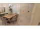 Dining room with a wooden table, seating for six, and a view of the front door at 3605 Kings Rd # 102, Palm Harbor, FL 34685