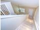 Bright entryway features tiled floors, a modern light fixture, and staircase leading upstairs at 3605 Kings Rd # 102, Palm Harbor, FL 34685