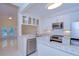 Bright kitchen with stainless appliances, granite counters, white cabinets, and open to living space at 3605 Kings Rd # 102, Palm Harbor, FL 34685