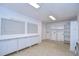 Bright laundry room featuring a large countertop, storage cabinets, and tile flooring at 3605 Kings Rd # 102, Palm Harbor, FL 34685