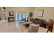 Living room with comfortable seating, a coffee table, and a view of the backyard at 3605 Kings Rd # 102, Palm Harbor, FL 34685