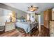 Main bedroom with a king-size bed, ceiling fan, and hardwood floors at 1533 Westerham Loop, Trinity, FL 34655