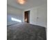 Empty bedroom with gray carpet, closet, white walls, ceiling light, and view of open closet at 8535 Bella Via, Hudson, FL 34667