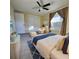 Staged bedroom with bed, seating, window with curtain, closet and view of the ocean at 8535 Bella Via, Hudson, FL 34667