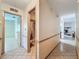 Hallway with tile flooring that leads to multiple rooms, including a bathroom with a shower at 10824 Peppertree Ln, Port Richey, FL 34668