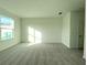 Spacious bedroom with large window and neutral carpet at 13447 Newport Shores Dr, Hudson, FL 34669