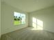 Bright bedroom with window and neutral decor at 13447 Newport Shores Dr, Hudson, FL 34669