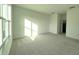 Spacious bedroom with large window and neutral carpet at 13447 Newport Shores Dr, Hudson, FL 34669