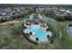 Aerial view of community pool and surrounding area at 13447 Newport Shores Dr, Hudson, FL 34669