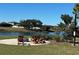 Relaxing fire pit area overlooking a lake at 13447 Newport Shores Dr, Hudson, FL 34669