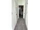 Clean hallway with carpet and access to bedrooms at 13447 Newport Shores Dr, Hudson, FL 34669