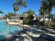 Community pool with adjacent clubhouse at 13447 Newport Shores Dr, Hudson, FL 34669