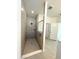 Large walk-in shower with grey tile at 13447 Newport Shores Dr, Hudson, FL 34669