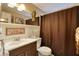 Clean bathroom with brown shower curtain and updated vanity at 1542 Derrick St, Holiday, FL 34690