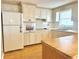 Kitchen with white appliances and wood cabinets at 1542 Derrick St, Holiday, FL 34690