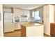 Kitchen with white appliances and wood cabinets at 1542 Derrick St, Holiday, FL 34690