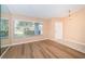 Light and airy living room featuring large windows and laminate flooring at 3631 Player Dr, New Port Richey, FL 34655