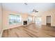 Bright living room with sliding doors to patio, fireplace and laminate flooring at 3631 Player Dr, New Port Richey, FL 34655