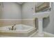 Elegant bathroom with pedestal sink, corner bathtub and shower at 3912 W San Pedro St, Tampa, FL 33629