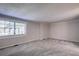 Bright bedroom with grey carpet and a large window at 3912 W San Pedro St, Tampa, FL 33629