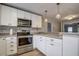 Modern kitchen with stainless steel appliances and white cabinets at 3912 W San Pedro St, Tampa, FL 33629