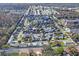 Aerial view of The Wilds community, showcasing numerous homes and a central pond at 6704 Hickorywood Ln # 2B, New Port Richey, FL 34653