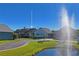 Cute house exterior view with pond and fountain at 6704 Hickorywood Ln # 2B, New Port Richey, FL 34653