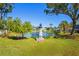 Landscaped pond with lighthouse feature in a tranquil community setting at 6704 Hickorywood Ln # 2B, New Port Richey, FL 34653