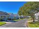 Street view of charming homes with lush landscaping at 6704 Hickorywood Ln # 2B, New Port Richey, FL 34653