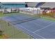 Community tennis court with fence and net at 6704 Hickorywood Ln # 2B, New Port Richey, FL 34653