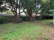 Large backyard with mature trees and grassy area at 7240 Nova Scotia Dr, Port Richey, FL 34668