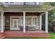 Large covered porch with brick steps and white columns at 804 S Fremont Ave, Tampa, FL 33606