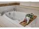 Soaking tub with wooden tray and decorative plants at 804 S Fremont Ave, Tampa, FL 33606