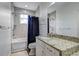 Bathroom with granite countertop, single sink vanity and shower/tub combo at 804 S Fremont Ave, Tampa, FL 33606