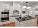 Gourmet kitchen featuring white cabinetry, granite island, and stainless steel appliances at 804 S Fremont Ave, Tampa, FL 33606