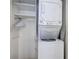 Stackable washer and dryer in a closet with shelving at 804 S Fremont Ave, Tampa, FL 33606