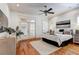 Spacious main bedroom with hardwood floors, a king-size bed, and French doors leading to the backyard at 804 S Fremont Ave, Tampa, FL 33606