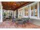 Relaxing screened porch with brick flooring and outdoor furniture at 804 S Fremont Ave, Tampa, FL 33606