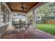 Brick patio screened porch with ceiling fan and outdoor furniture at 804 S Fremont Ave, Tampa, FL 33606