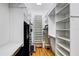 Spacious walk-in closet with built-in shelves and hanging rods at 804 S Fremont Ave, Tampa, FL 33606