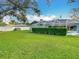 Landscaped backyard, pool, and screened enclosure at 6206 Soaring Ave, Temple Terrace, FL 33617