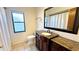 Bathroom with granite vanity, tiled floor, and updated fixtures at 6206 Soaring Ave, Temple Terrace, FL 33617