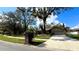 Ranch home with a brick facade, attached garage, and mature trees at 6206 Soaring Ave, Temple Terrace, FL 33617