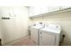 Bright laundry room with white cabinets and a utility sink at 6206 Soaring Ave, Temple Terrace, FL 33617