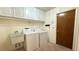 Laundry room with washer, dryer, cabinets, and utility sink at 6206 Soaring Ave, Temple Terrace, FL 33617